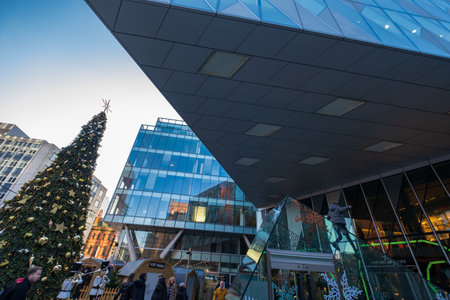Manchester, United Kingdom - November 29, 2019: A boy climbs up a Christmas-decorated glass structure in Spinningfields modern development area of Manchester.のeditorial素材