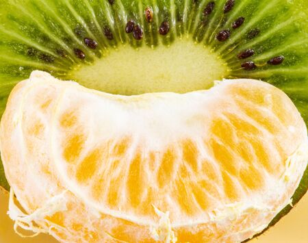 Sliced kiwi and fresh Tangerine close-upの写真素材
