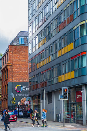 Manchester, United Kingdom - March 1, 2020: People walk past traffic lights in Ancoats area of Manchesterのeditorial素材