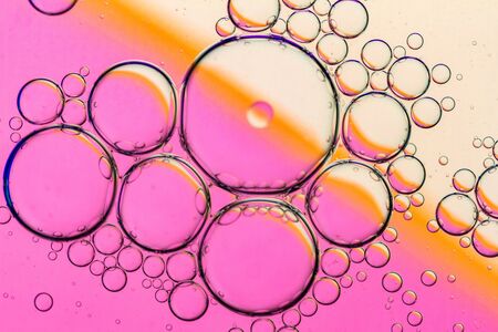 Abstract Background of Oil Bubbles on Water Surface pink salmon colorful palette. Macro close-up shot.の写真素材