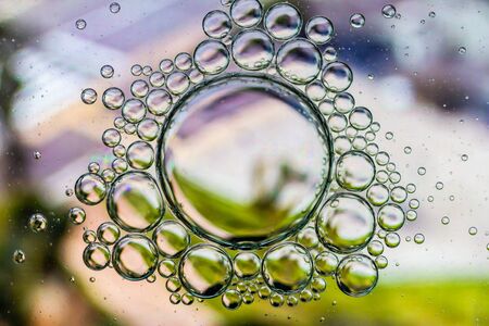 Abstract Background of Oil Bubbles on Water Surface purple white olive green palette. Macro close-up shot.の写真素材