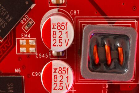 Electronic Printed Circuit Board in red with Electronic components viewed from aboveの写真素材
