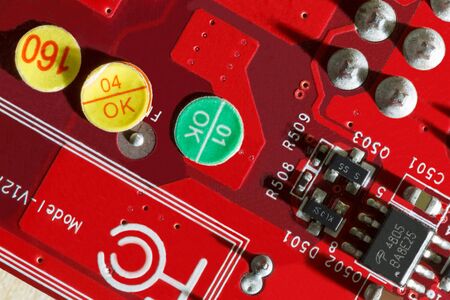 Electronic Printed Circuit Board in red with Electronic components viewed from above