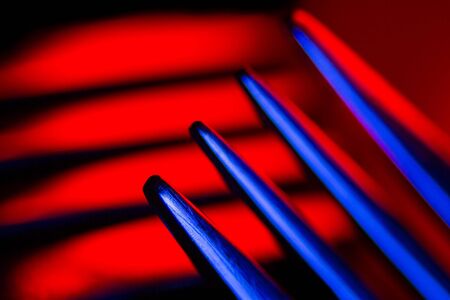 Prongs of one fork in colorful illumination macro shot creating an abstract composition. Image is suitable as a background.の写真素材