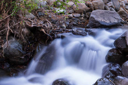 Pure water stream with smooth flow over rocky mountain terrain in the Kakopetria forest in Troodos,...