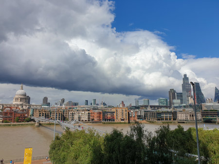 London, United Kingdom - July 30, 2021: Thames, St Paul's Cathedral and the City of London, business district set against a dramatic sky as seen from the Tate Modern Galleryのeditorial素材