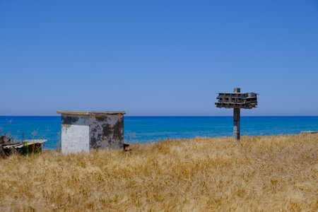 Abandoned wooden pigeon nest and other construction in a barley field overlooking the sea at Argaka village in Cyprusの写真素材