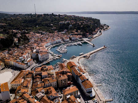 Aerial view on Piran town with Tartini main square, ancient buildings with red roofs, the port of Piran with reflecting boatsÂ  and Adriatic sea in southwestern Sloveniaのeditorial素材