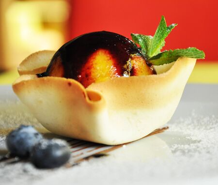 Dessert cake in basket with sprig of mint and blueberriesの写真素材