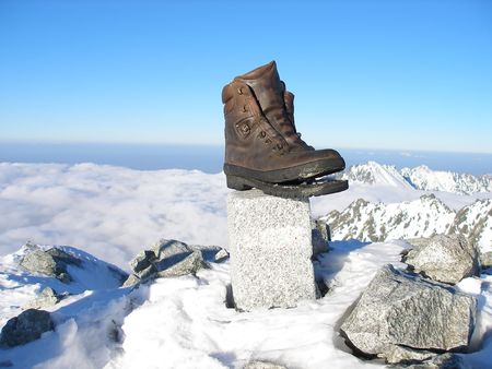 Old weather shoe forgotten on top of mountainの写真素材