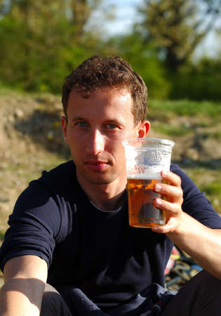 Man holding glass of beerの写真素材