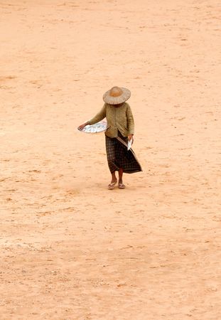 Poor woman carrying waiter of foodの写真素材