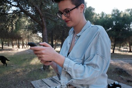 Young woman and youtuber shows her work on social media.の写真素材