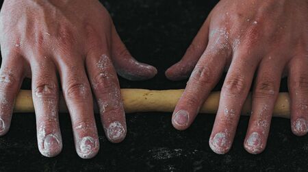 homemade potato gnocchis handmade with flour and egg on a black tableの写真素材