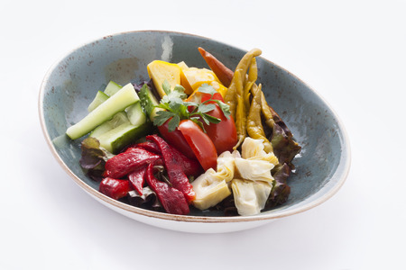pickled and fresh vegetables on the plateの写真素材