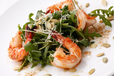 arugula salad with shrimps and pumpkin seedsの写真素材