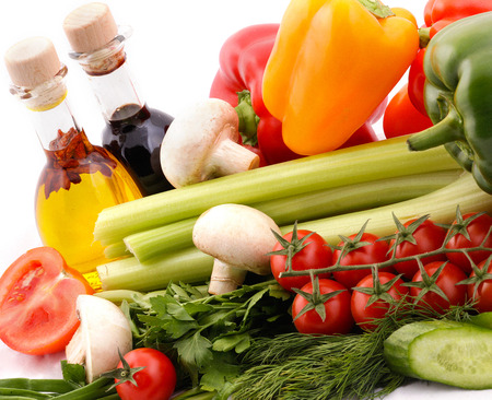 Composition with vegetables and salad dressingの写真素材