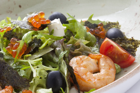 arugula salad with shrimp , cheese , black olives decorated with caviar.の写真素材