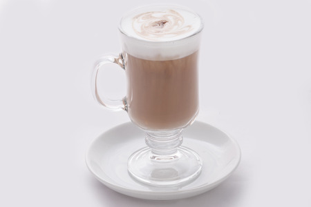 cappuccino latte in a transparent glass on a white backgroundの写真素材