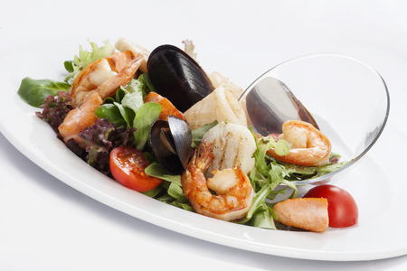 seafood salad on a white plateの写真素材
