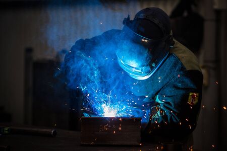 man welds parts