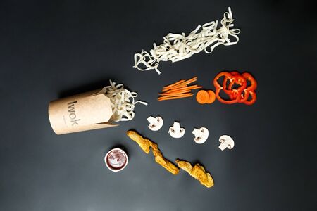 traditional wok noodles in box on dark backgroundの写真素材