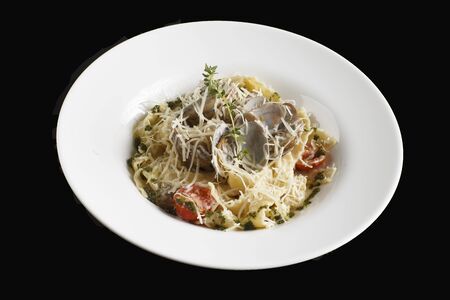 Seafood Pasta with mussels and basil in white plateの写真素材
