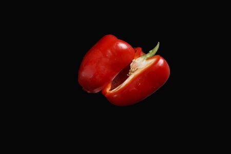 sweet pepper in a cut isolated on a black backgroundの写真素材