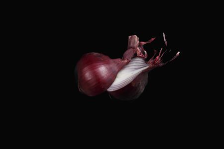 red onion in cut isolated on black backgroundの写真素材