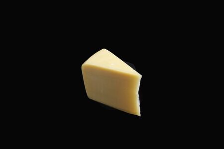piece of cheese on a black backgroundの写真素材