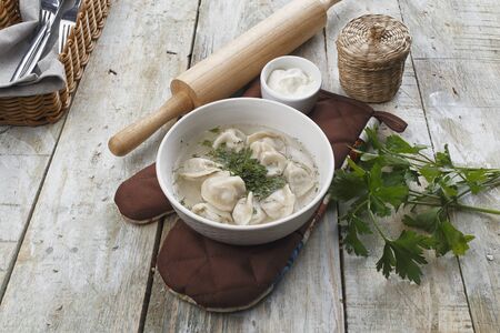 Dumplings with broth in a plateの写真素材