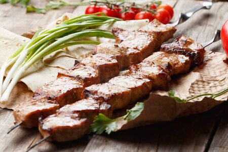 pork skewers on a wooden table, selective focusの写真素材
