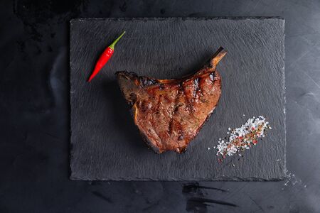 boneless steak, on stone dark background. steak house