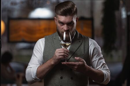 Professional sommelier man with a glass of white wine. selective focusの写真素材
