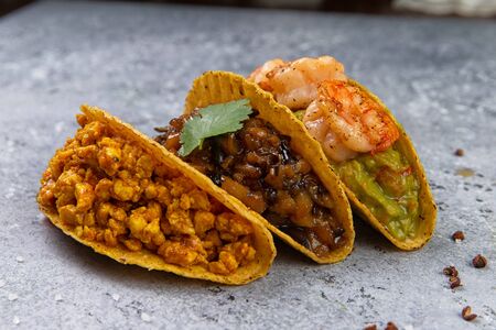 Fresh juicy tacos on a gray background. Close-up. Selective focusの写真素材