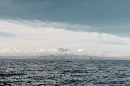 Mountains surrounded by clouds. Near the sea