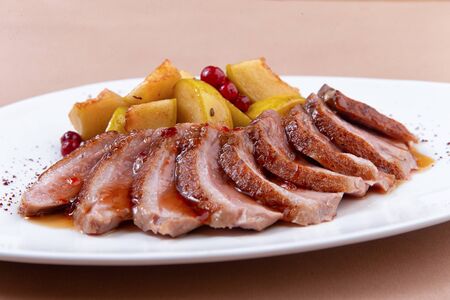 fried duck fillet with pear on a plate. close-up. selective focusの写真素材