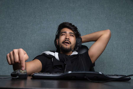 Young guy gamer playing an online video game.