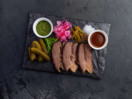 Sliced cooked meat, pickled cucumbers