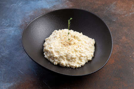traditional Italian risotto in a dark plateの写真素材