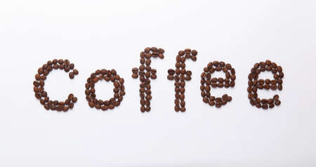 word coffee lined with coffee beans on white backgroundの写真素材