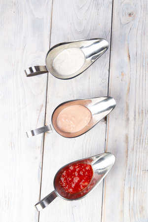 Three different sauces. on a light wood background. selective focusの写真素材