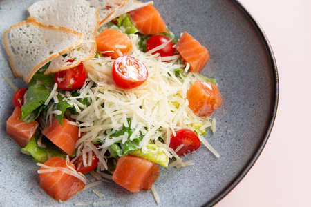 Salad with slices of salmon and tomatoes in a plate. Selective focusの写真素材