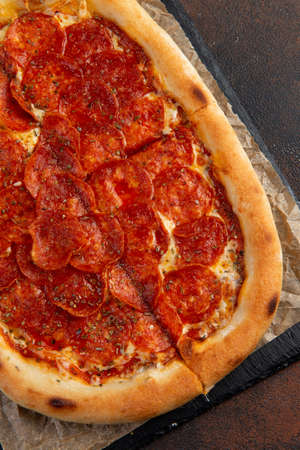 Pepperoni Pizza - Fresh homemade pizza with pepperoni, cheese and tomato. Selective focusの写真素材