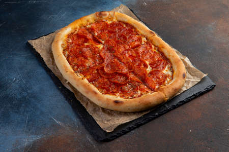 Pepperoni Pizza - Fresh homemade pizza with pepperoni, cheese and tomato. Selective focusの写真素材