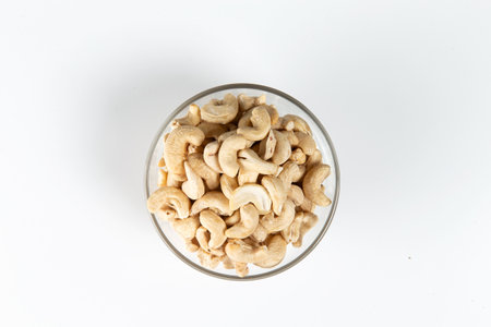 cashews in a glass cup on a white background. Close-up. Selective focus.の写真素材