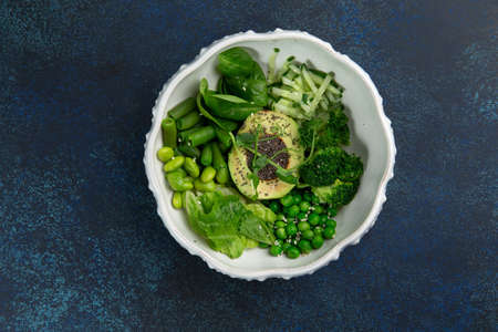 Poke with avacado, herbs and beans in a plate. Against a dark background. Selective focus.の写真素材
