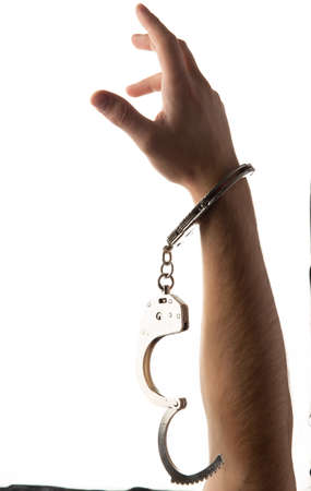 Handcuffed hands isolated on white background.
