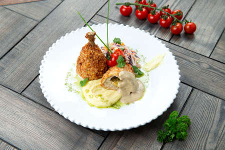 Chicken Kiev in a plate. on a wooden background. Selective focus.の写真素材