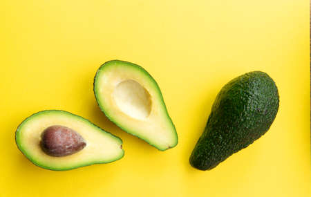 Two avocados on a yellow background. Selective focus.の写真素材